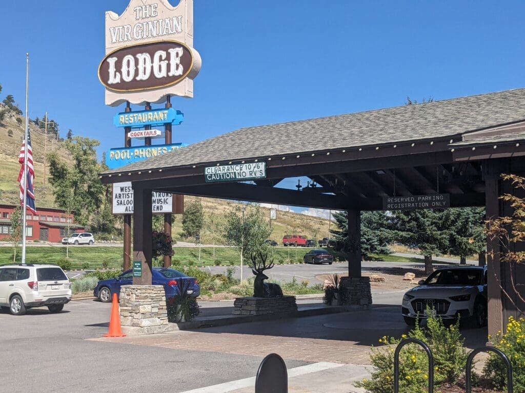 a building with a sign and cars parked in front of it