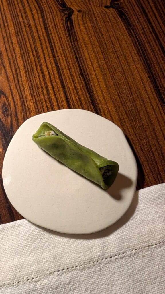 a green food on a white plate