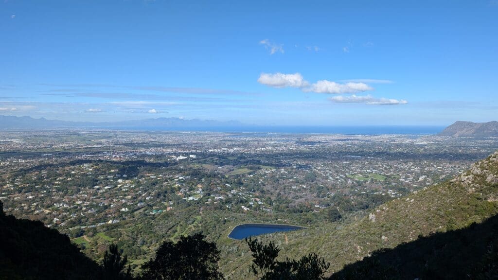 a landscape with a body of water and a city