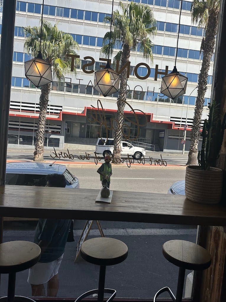 a window with palm trees and a statue on a table