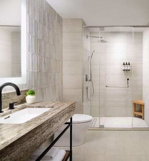 a bathroom with a glass shower and sink