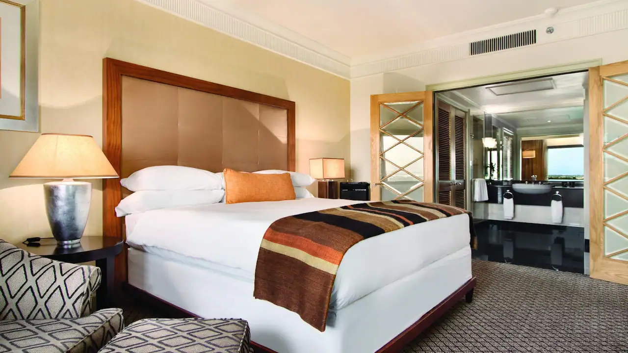 a hotel room with a bed and a glass door