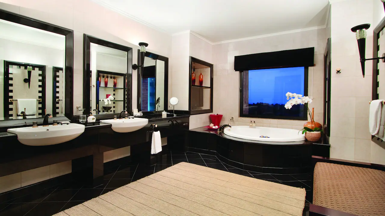 a bathroom with a large tub and a large mirror