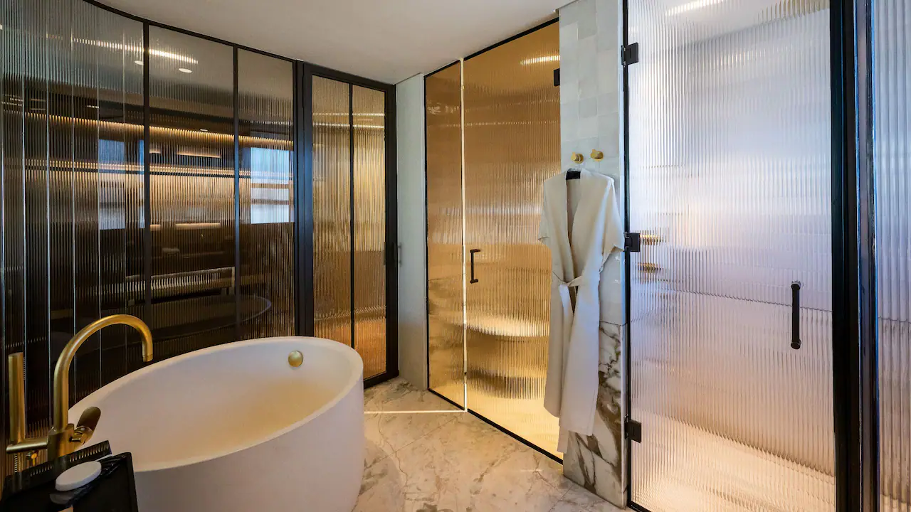a bathroom with a bathtub and shower doors