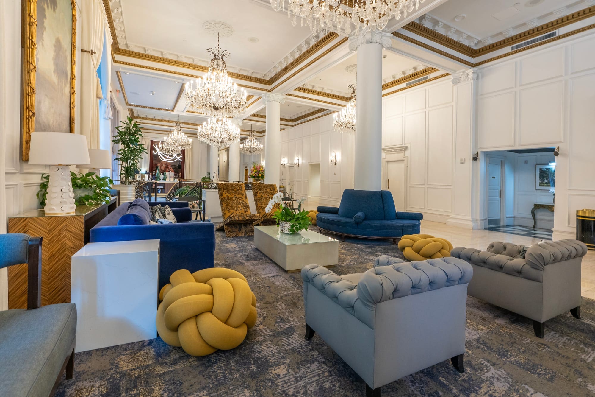 a large room with chandeliers and couches