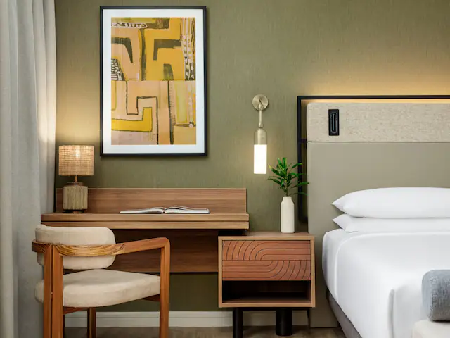 a room with a bed and a desk and chair