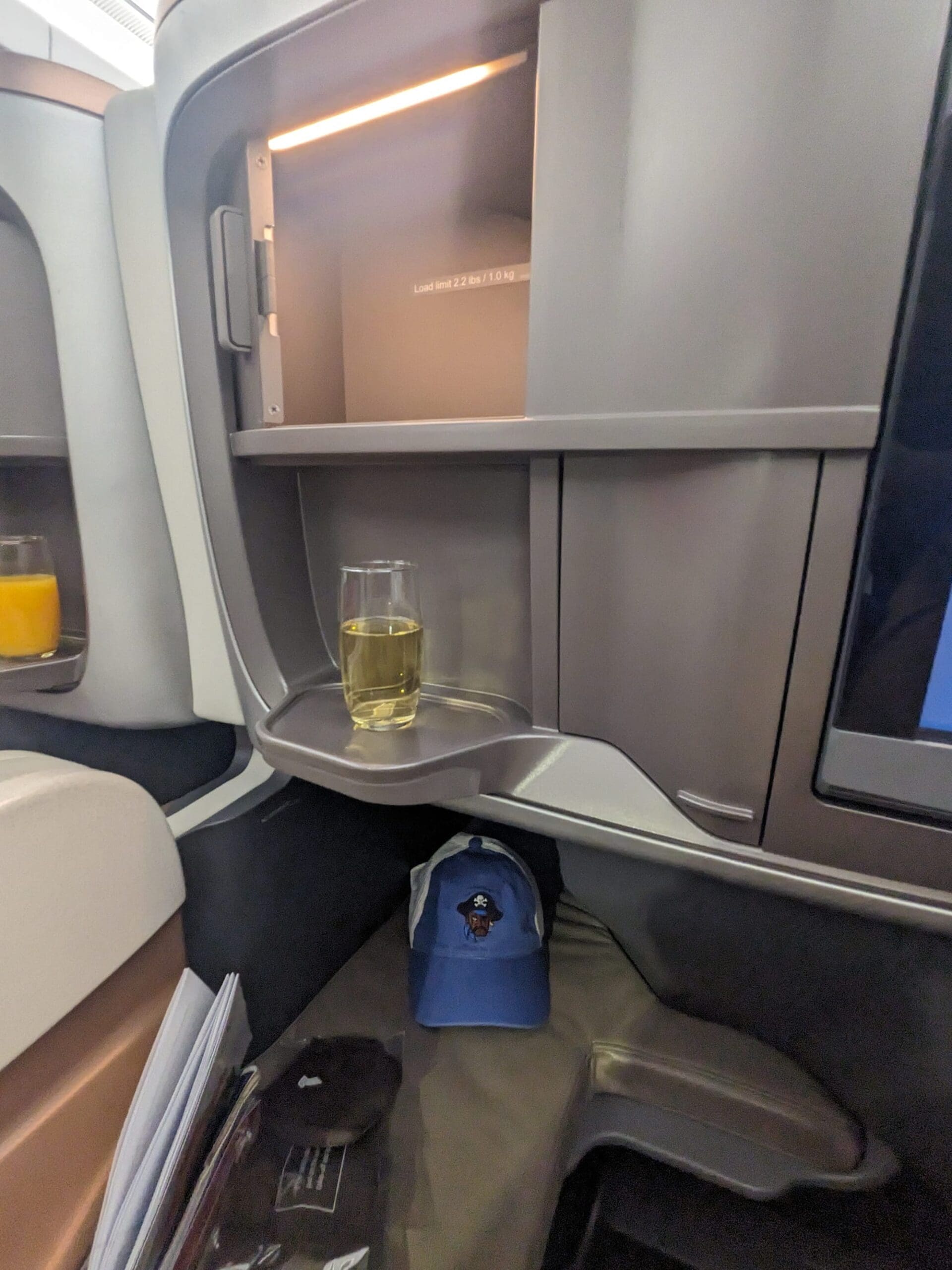 a glass on a shelf in an airplane