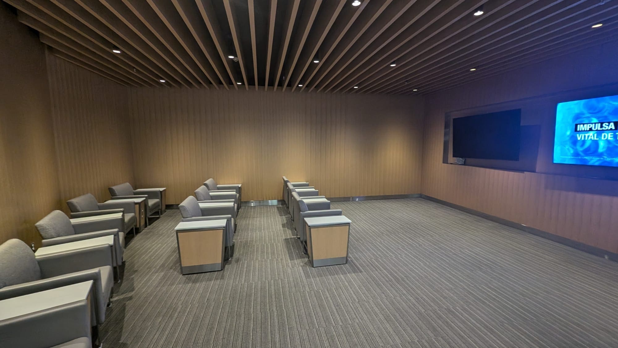 a room with chairs and a television