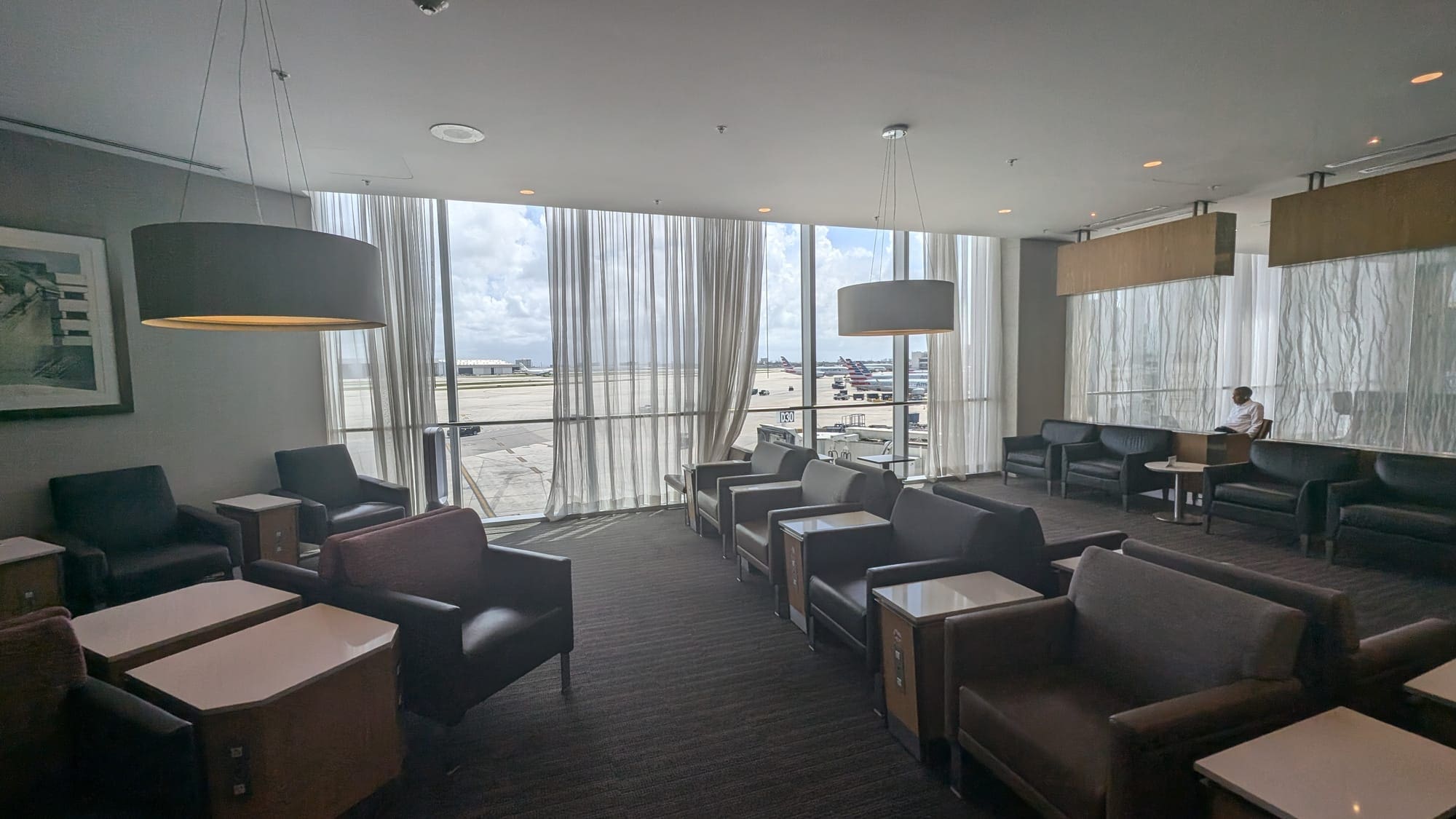 a room with chairs and tables and windows