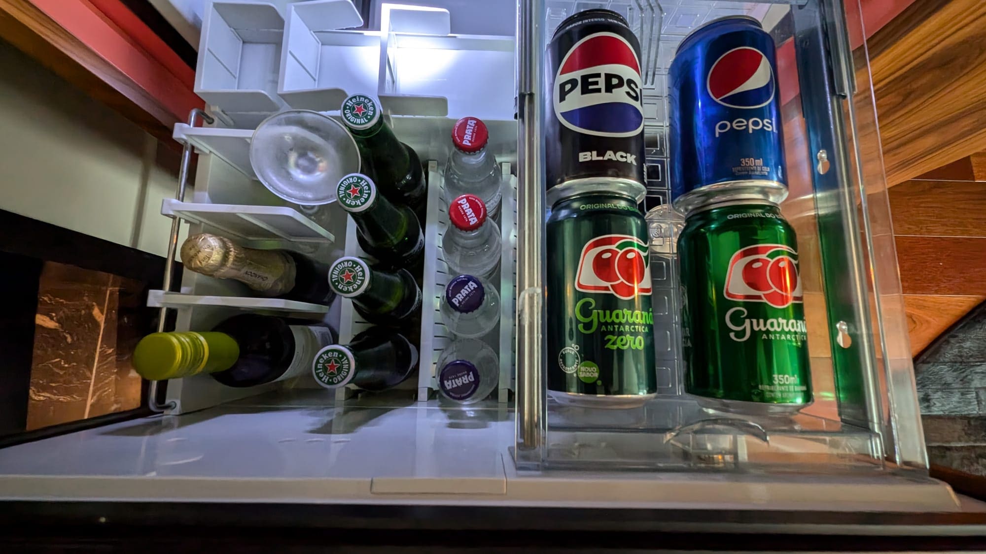 a refrigerator with cans of soda and bottles