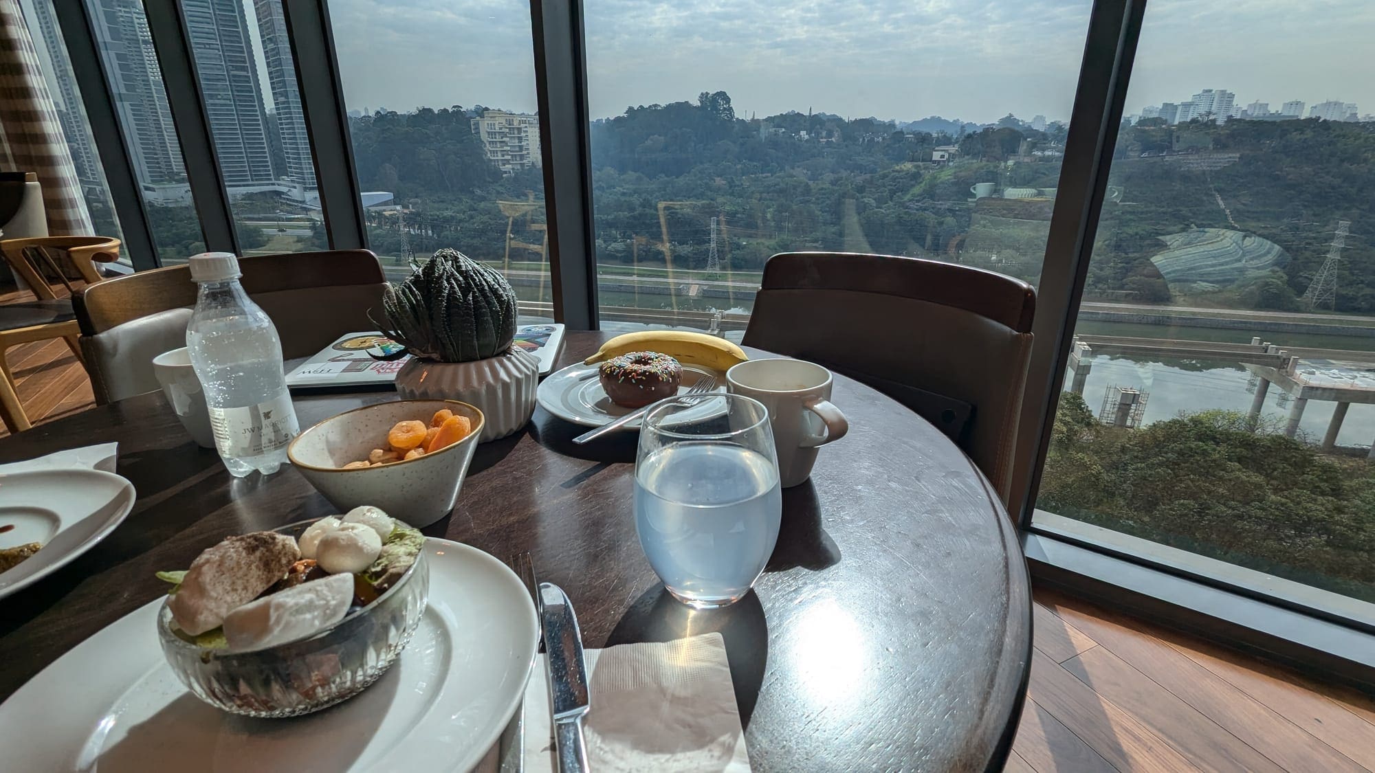 a table with food on it and a glass of water and a plant on it