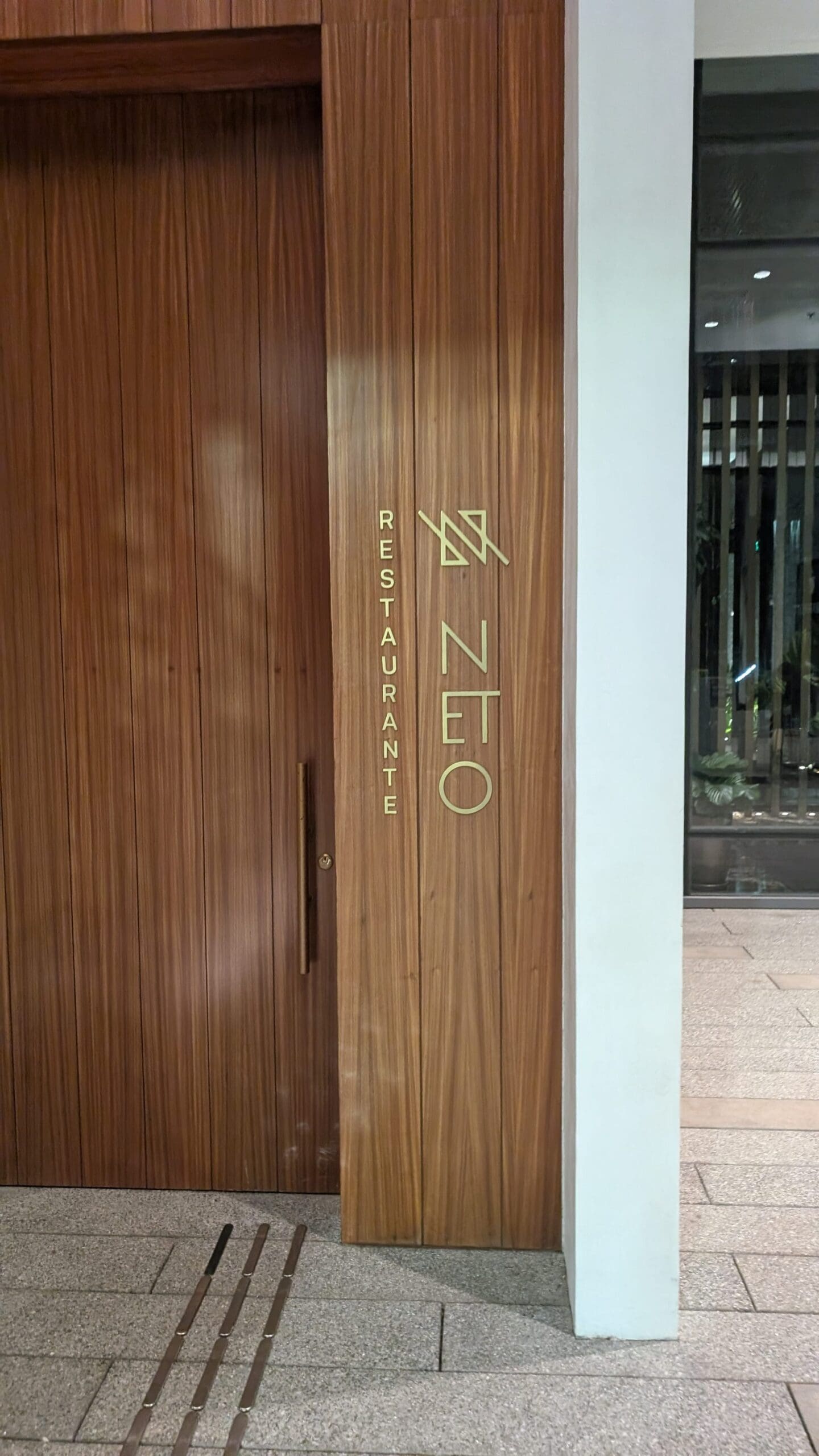 a wooden door with gold lettering