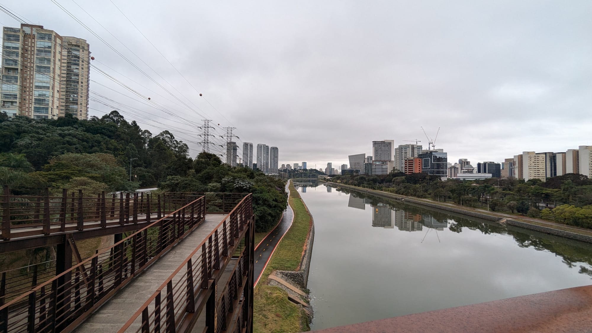 a bridge over a river with a city in the background