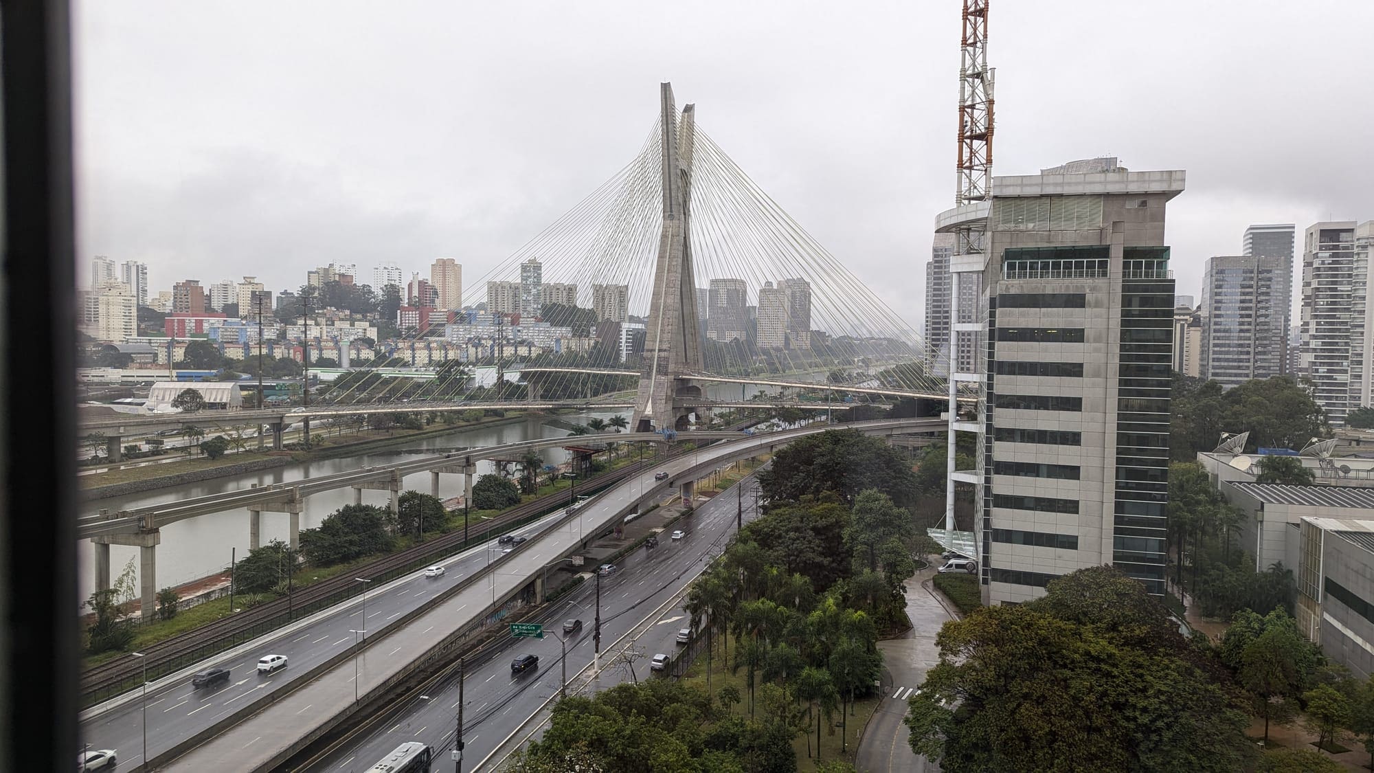 a bridge over a river with trees and buildings