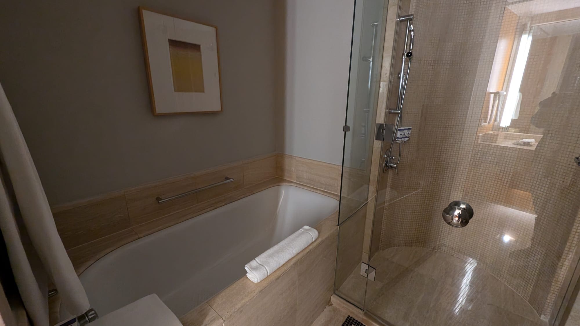 a bathroom with a glass shower door and a bathtub