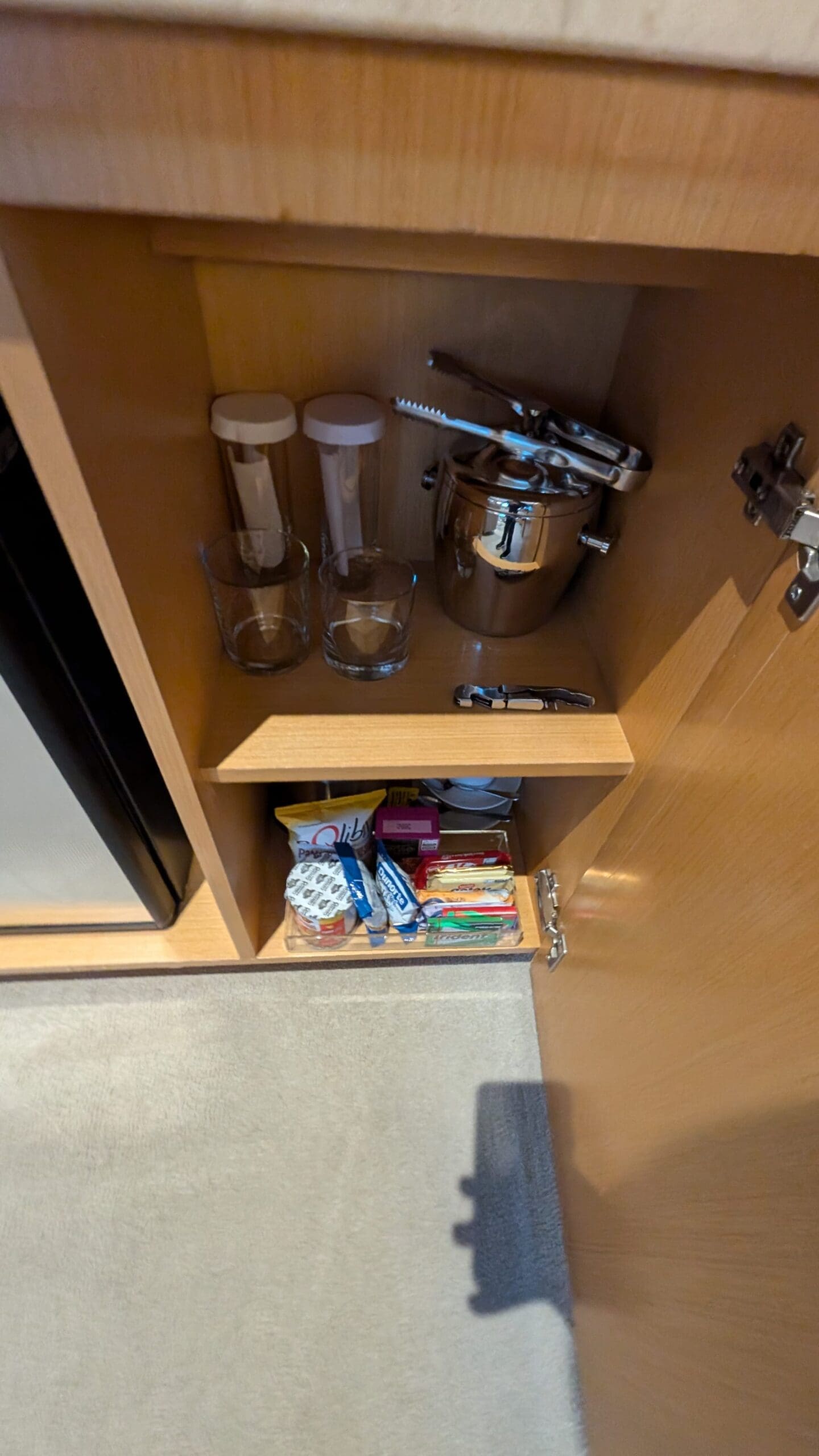 a cabinet with a shelf full of items