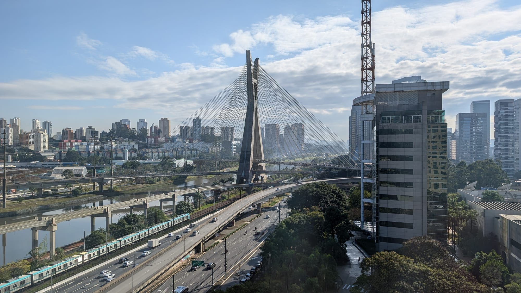a bridge with a bridge and a city in the background