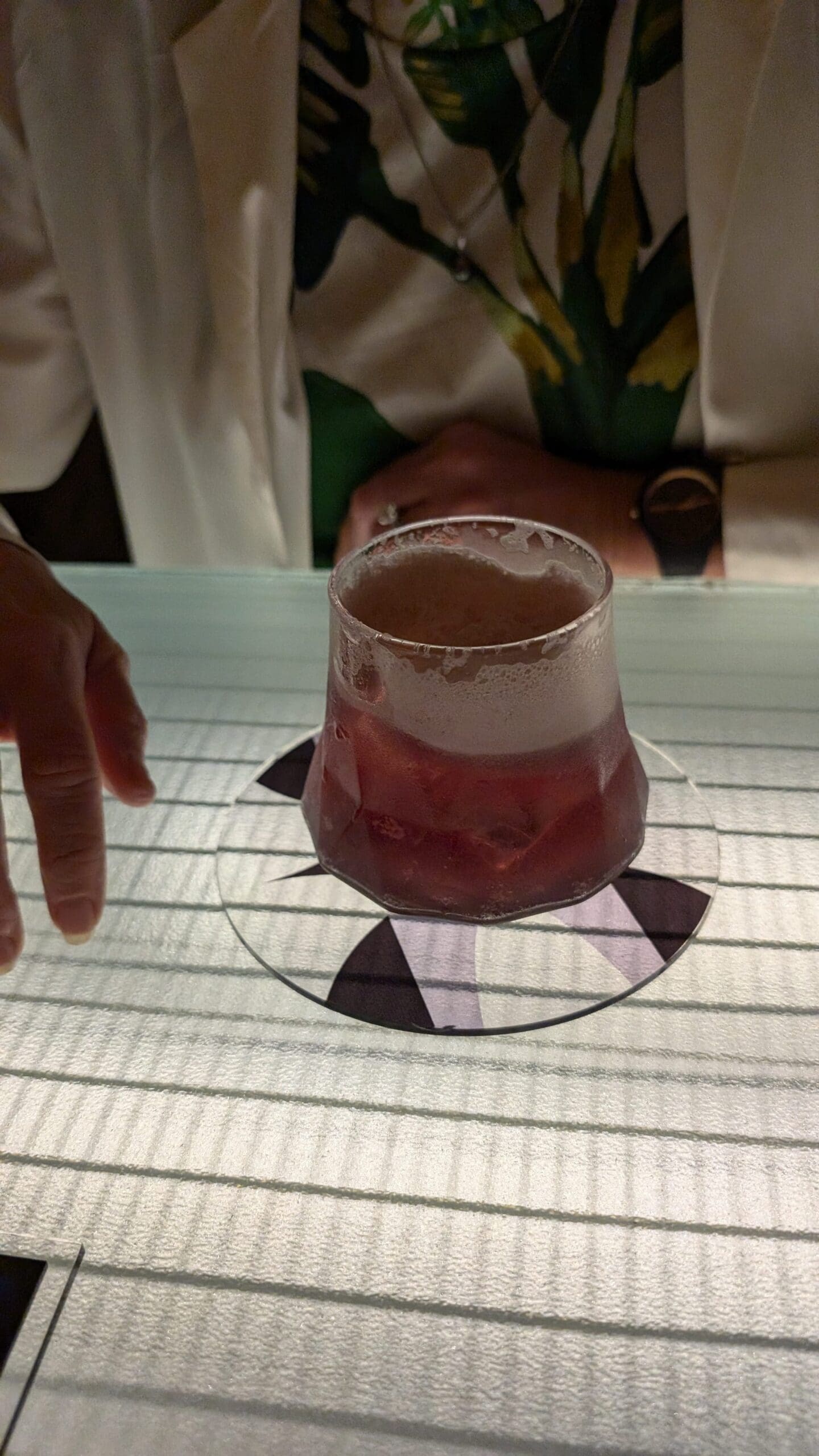a glass with a drink on it