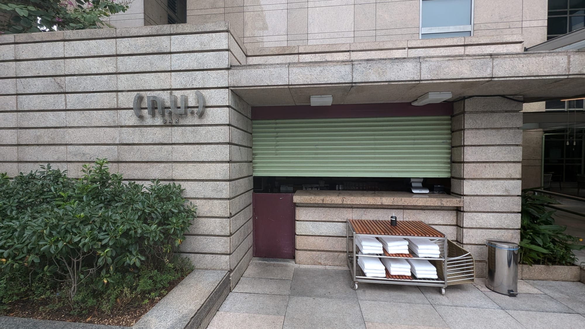 a building with a rolling cart and a sign