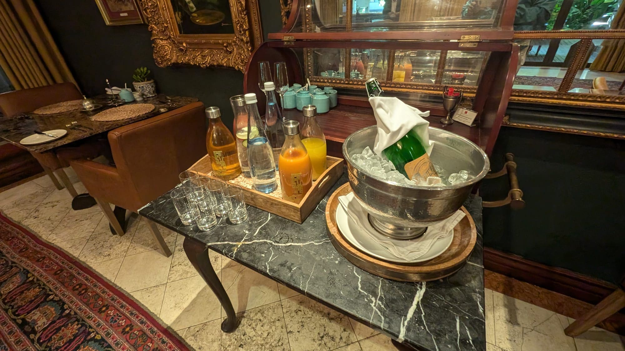 a table with a bucket of liquid and glasses