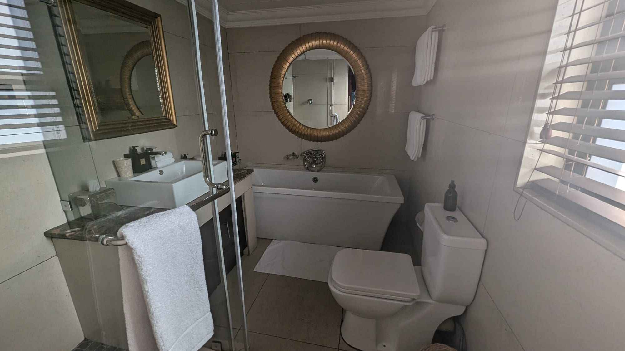 a bathroom with a tub and a mirror