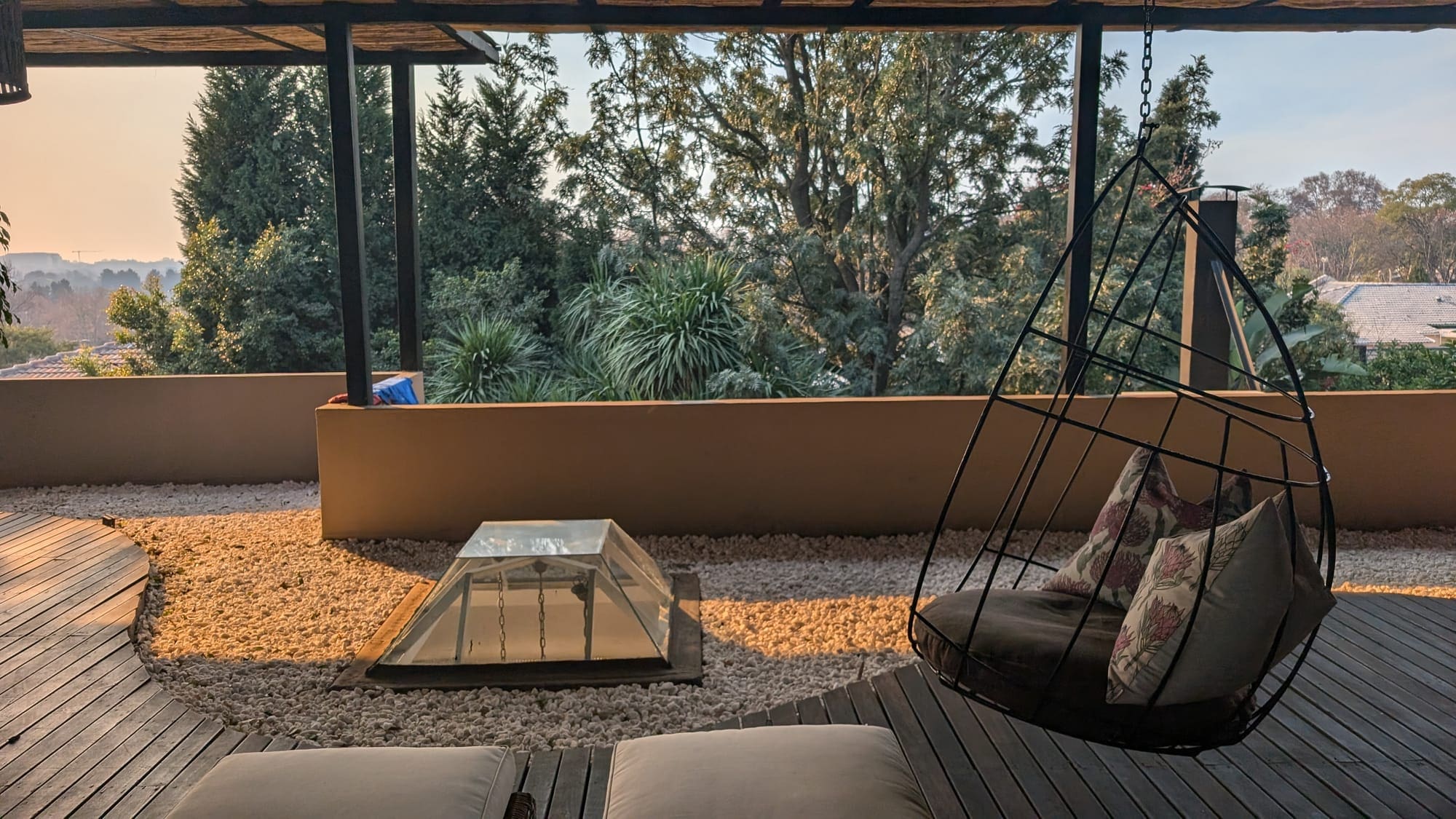 a patio with a chair and a glass dome