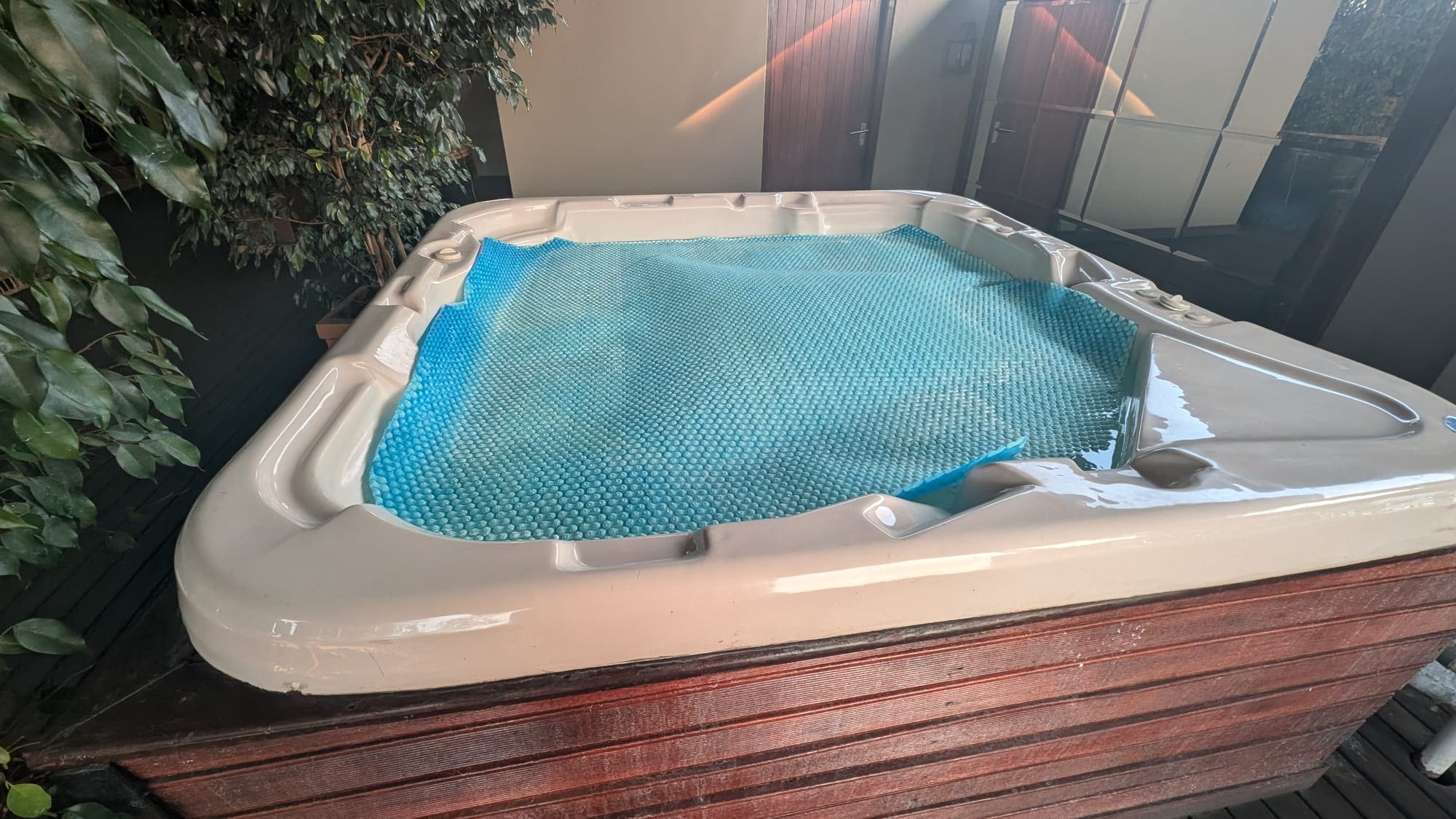 a hot tub with a blue sheet on top