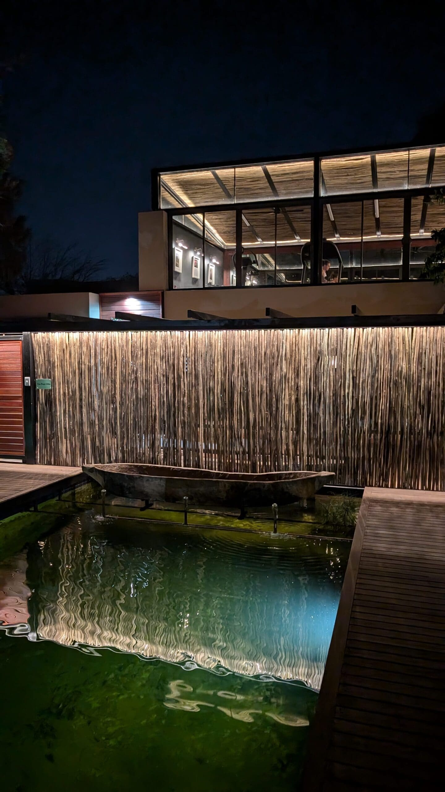 a boat in a pond by a building