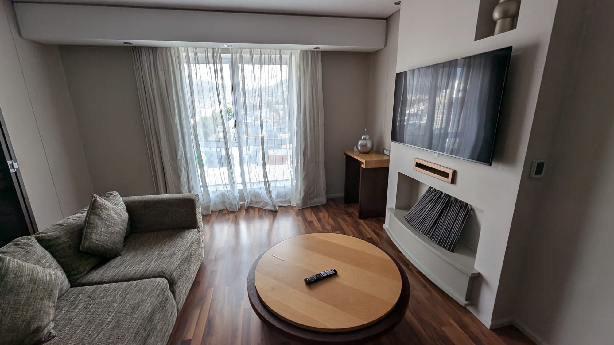 a living room with a television and a table