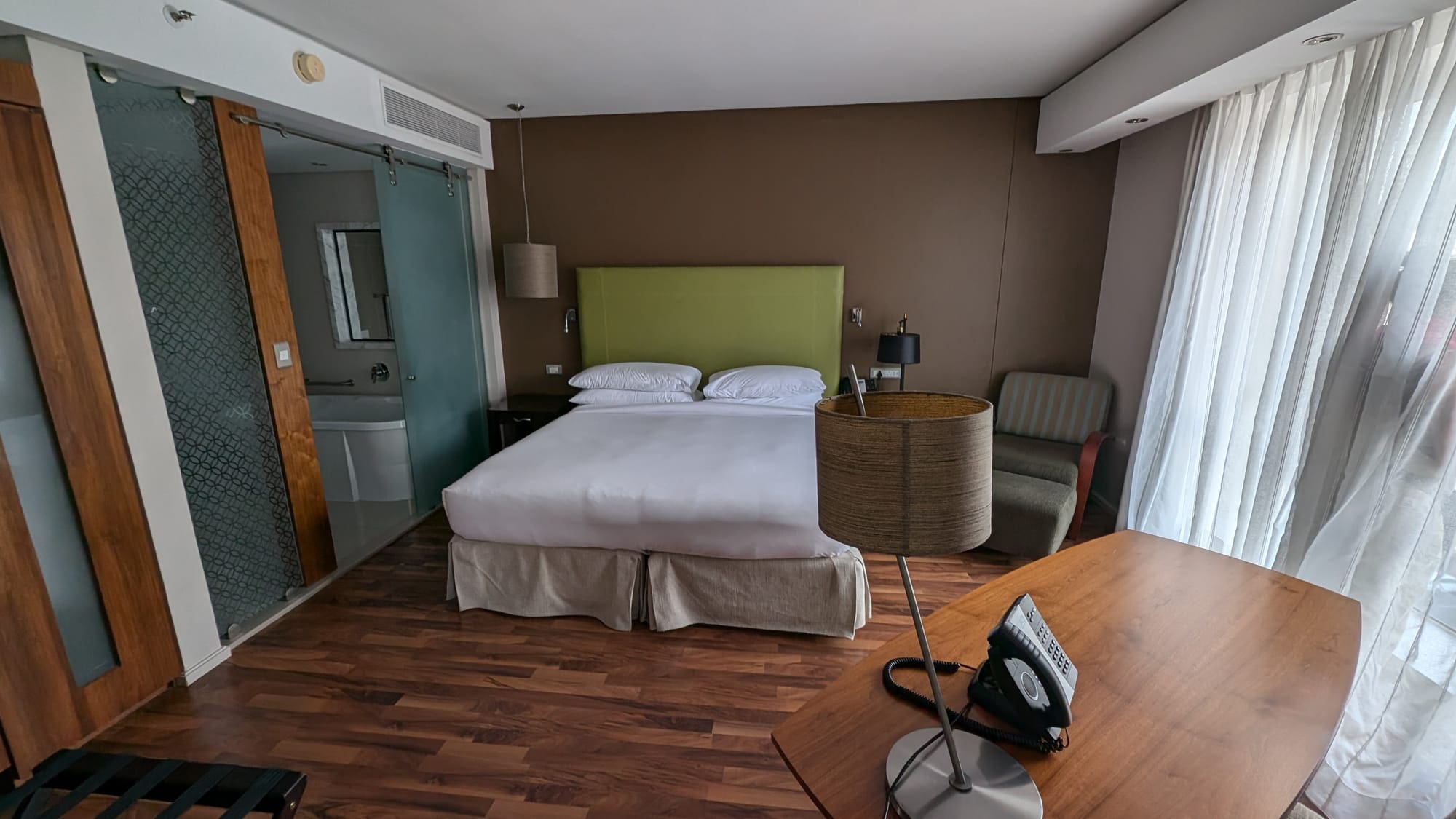 a hotel room with a bed and a desk