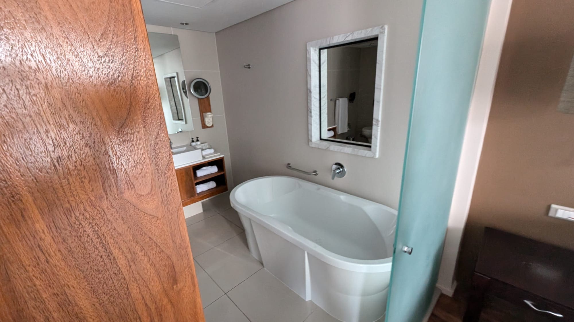 a bathroom with a tub and mirror