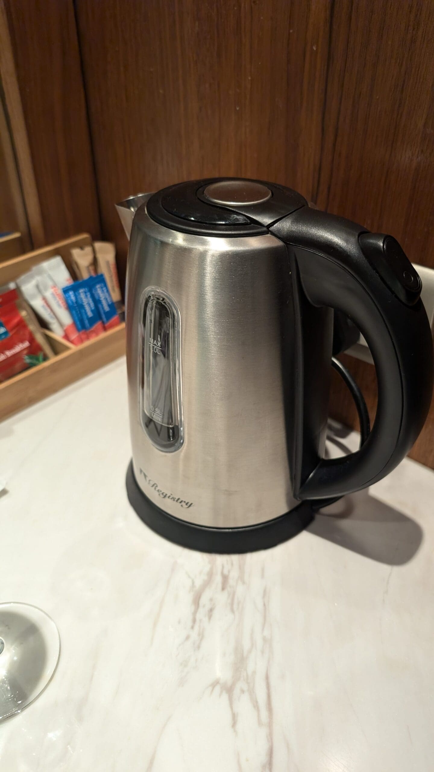 a silver and black kettle on a counter