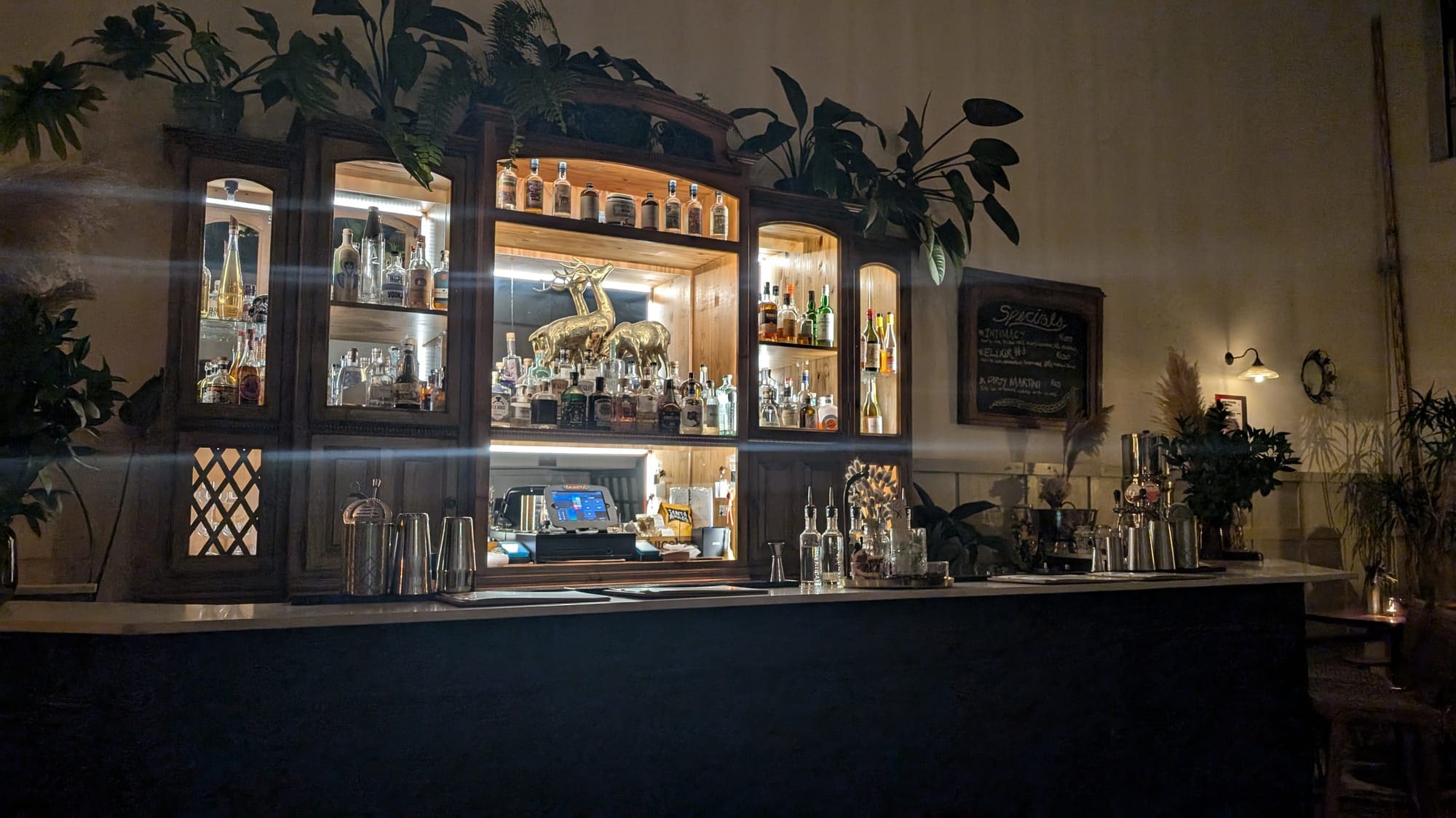 a bar with shelves of liquor and bottles