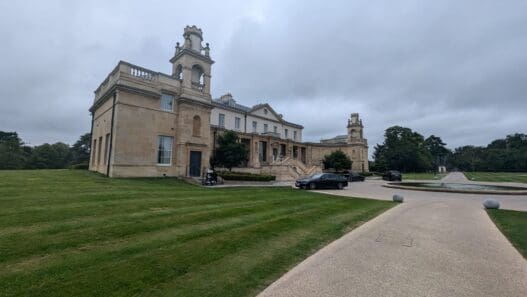 a building with a lawn and cars parked in front of it