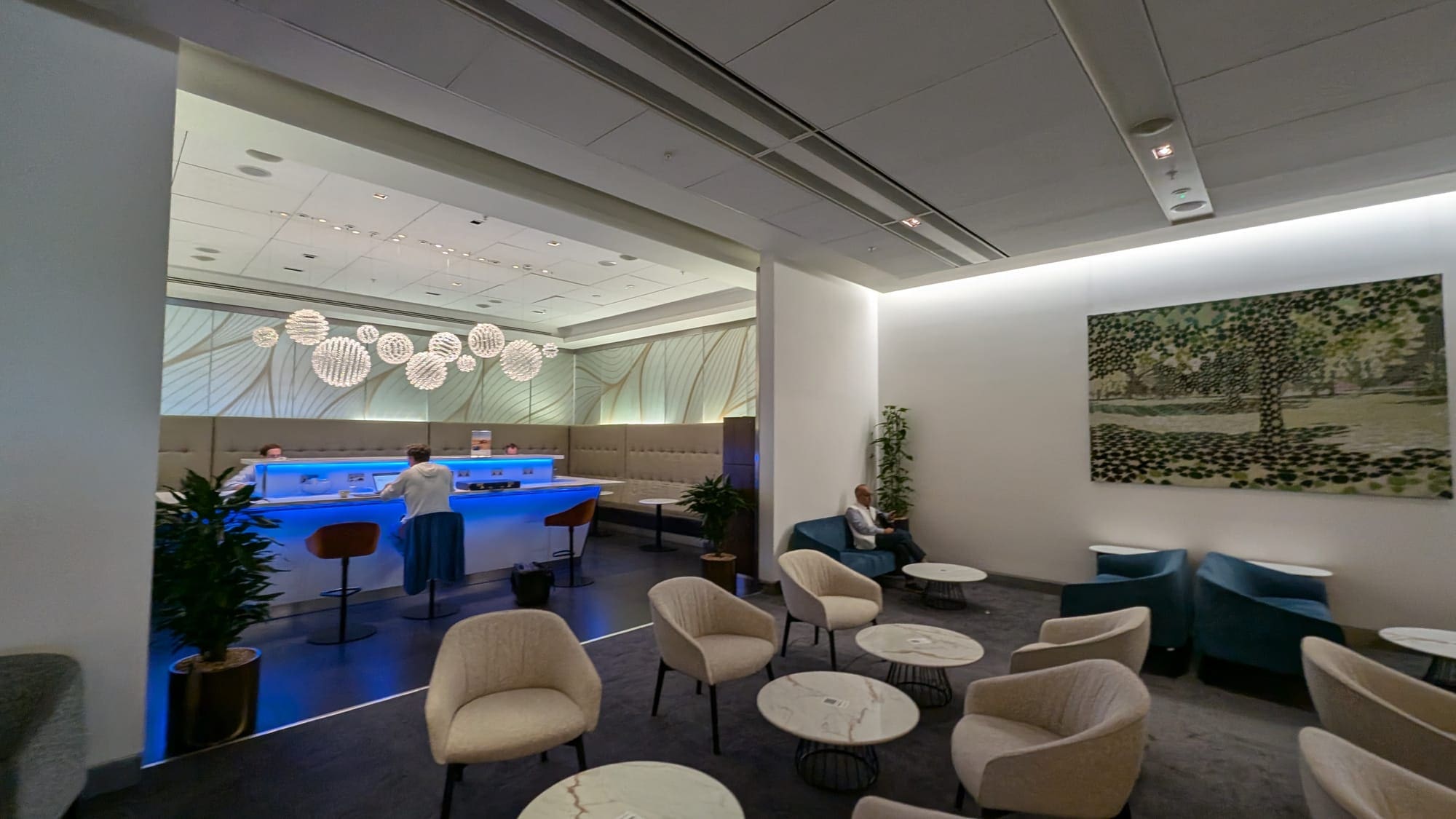 a room with a bar and chairs