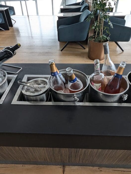 a group of bottles in buckets on a bar