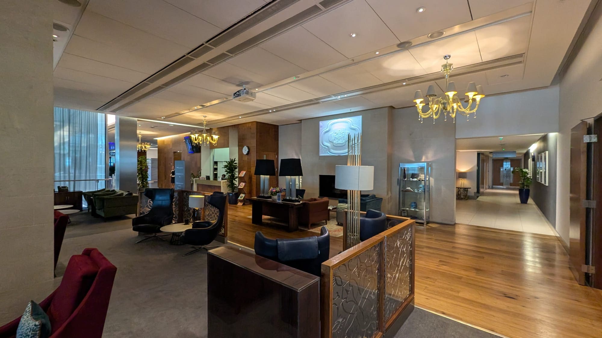 a lobby with a chandelier and chairs