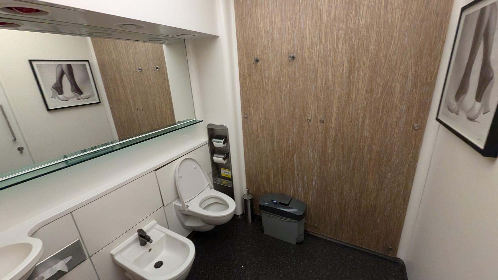 a bathroom with a toilet and a mirror