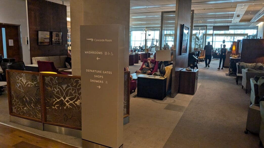 a room with a sign and chairs