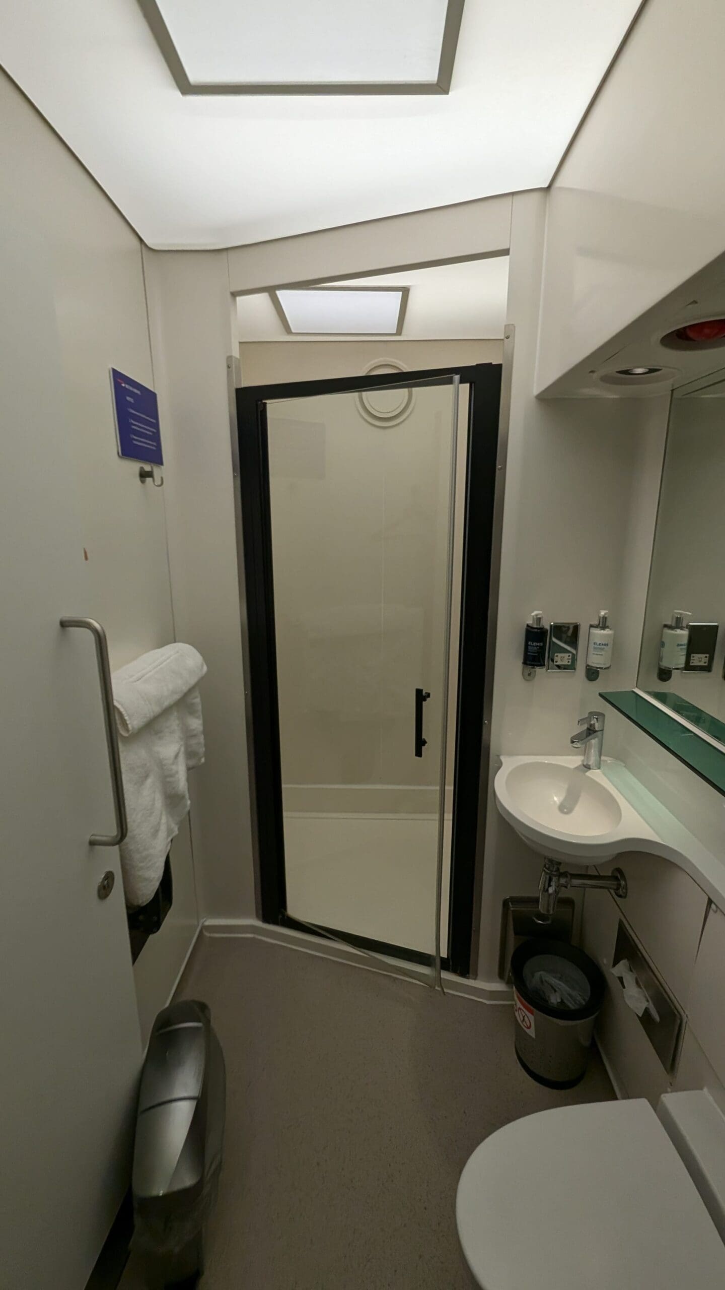 a bathroom with a glass door and sink