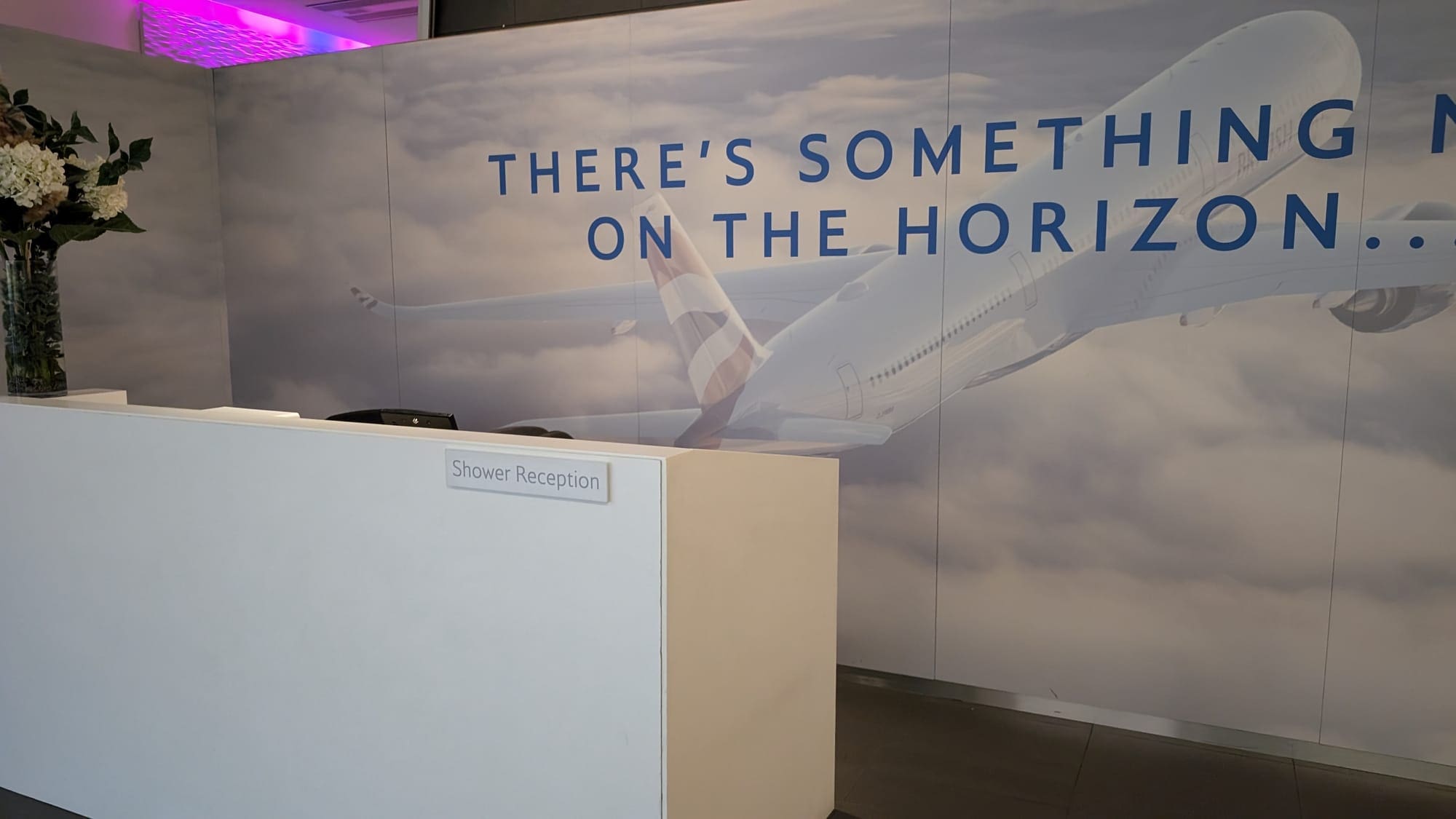 a reception desk with a picture of an airplane