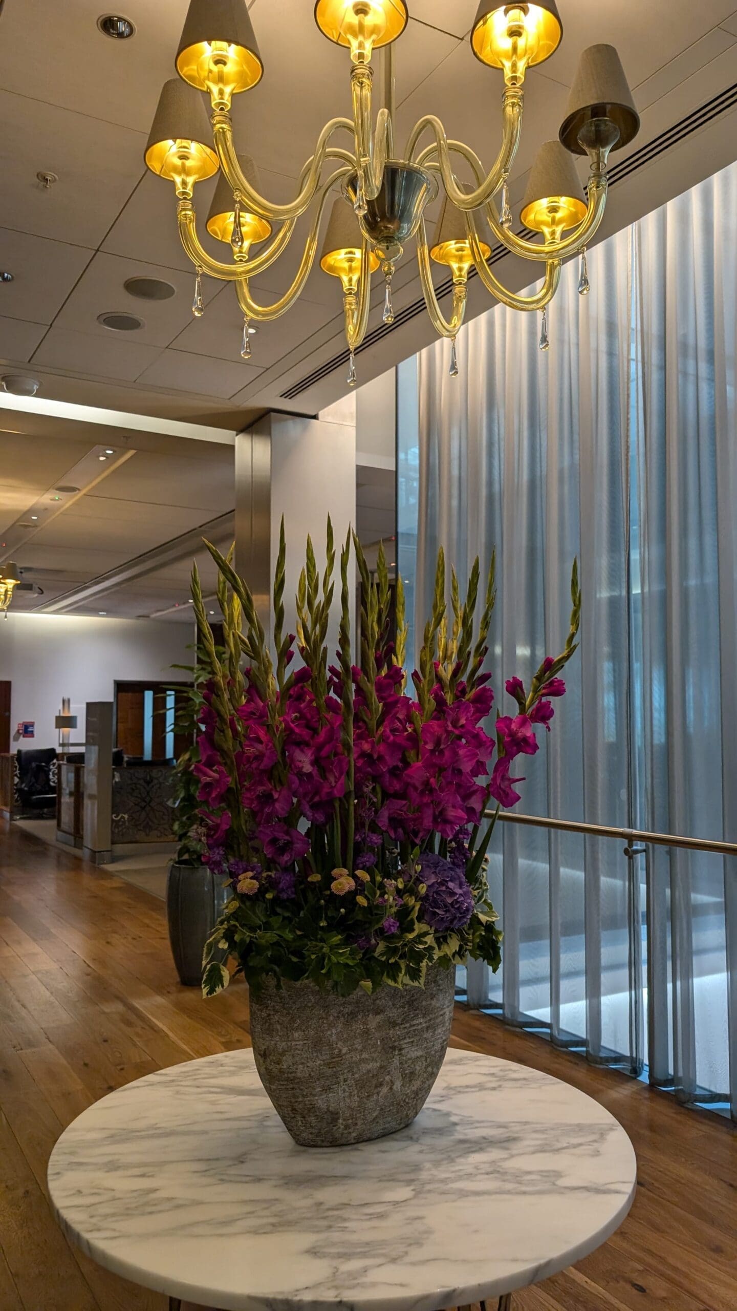 a large pot of flowers in a room