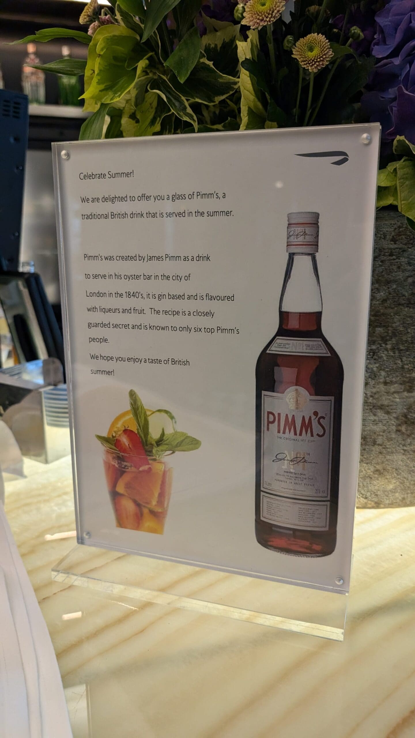 a sign with a bottle and a drink
