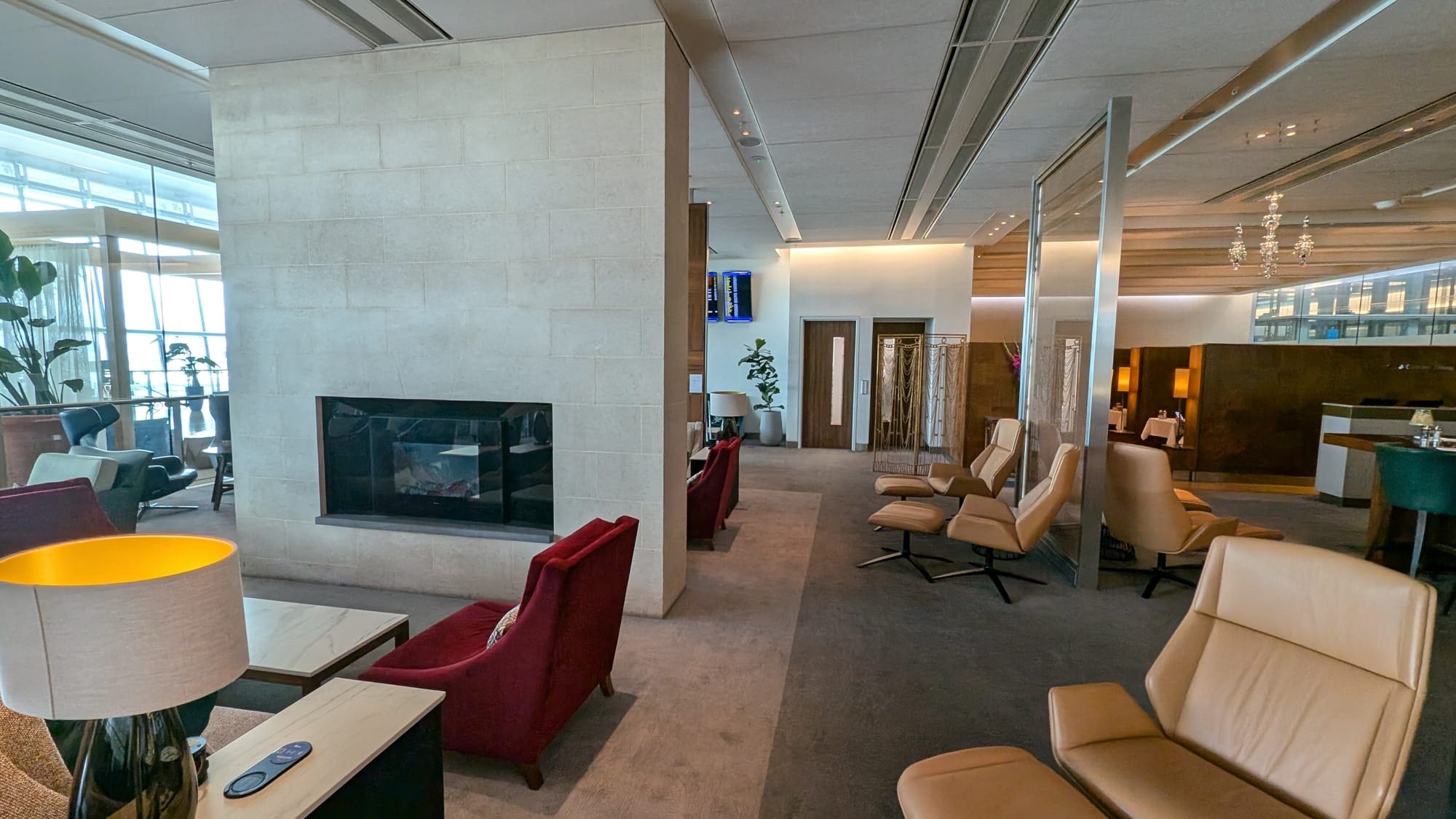a room with a fireplace and chairs