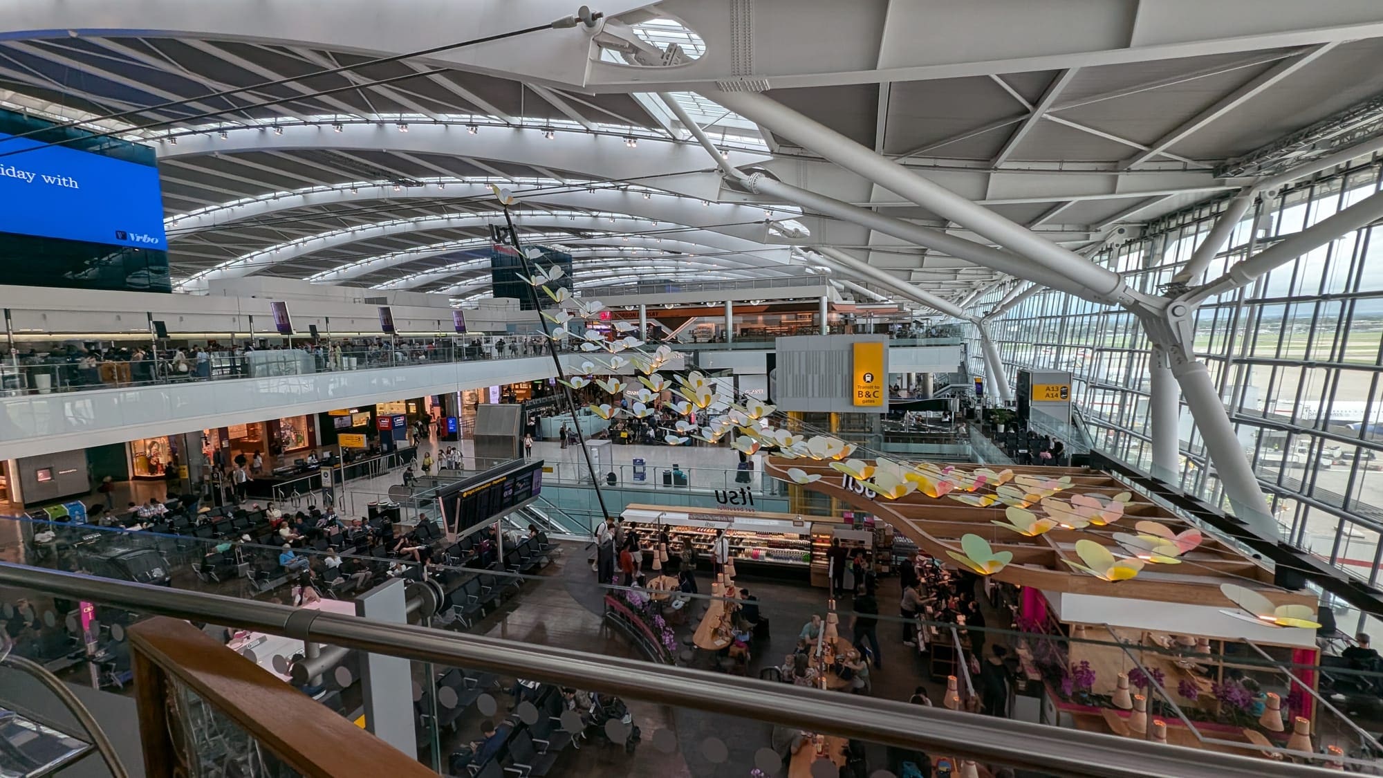 a large building with many people and a pool