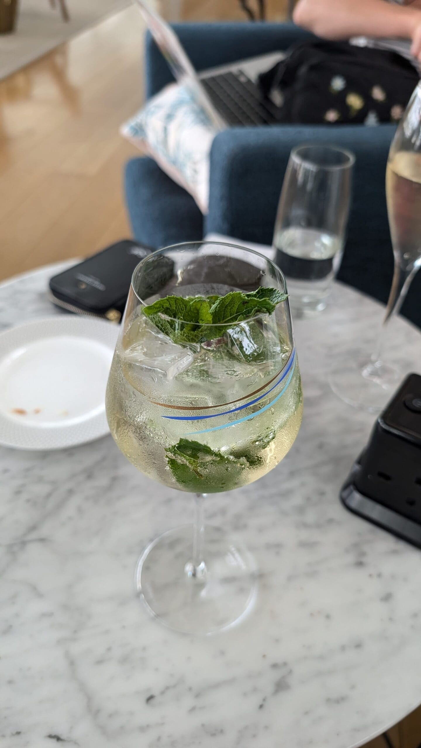 a glass of liquid with mint leaves