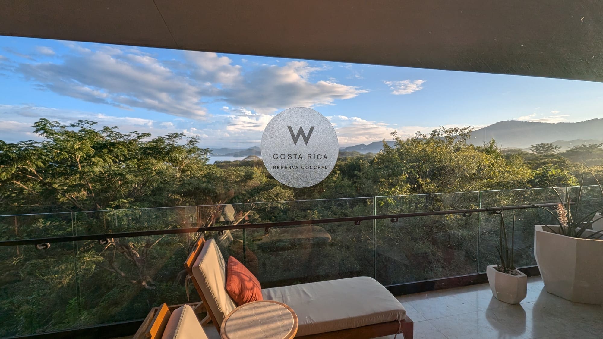 a balcony with a view of trees and mountains