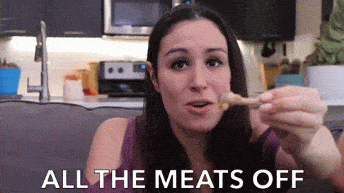 a woman eating food on a couch
