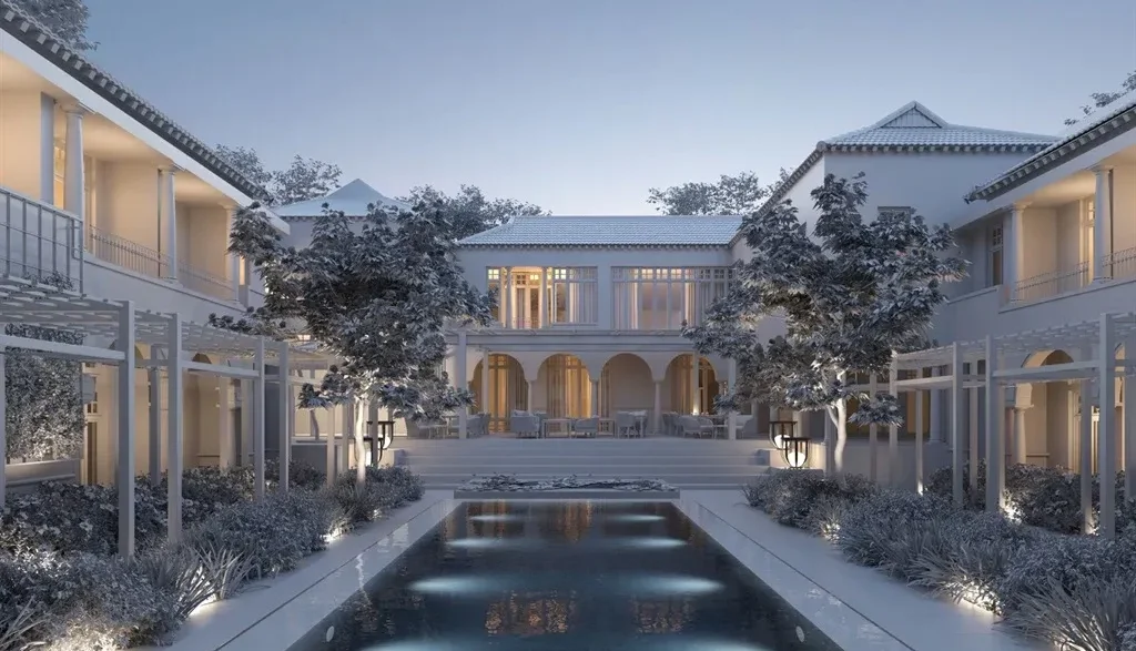 a large white house with a pool in front of it