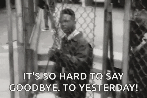 a man standing behind a chain link fence